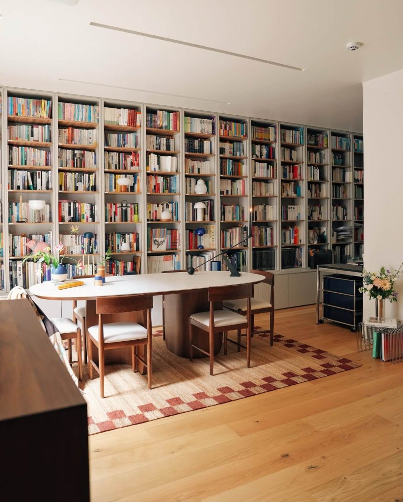 Elegant Modern Bookshelf Wall Enhancing a Bright Office Space