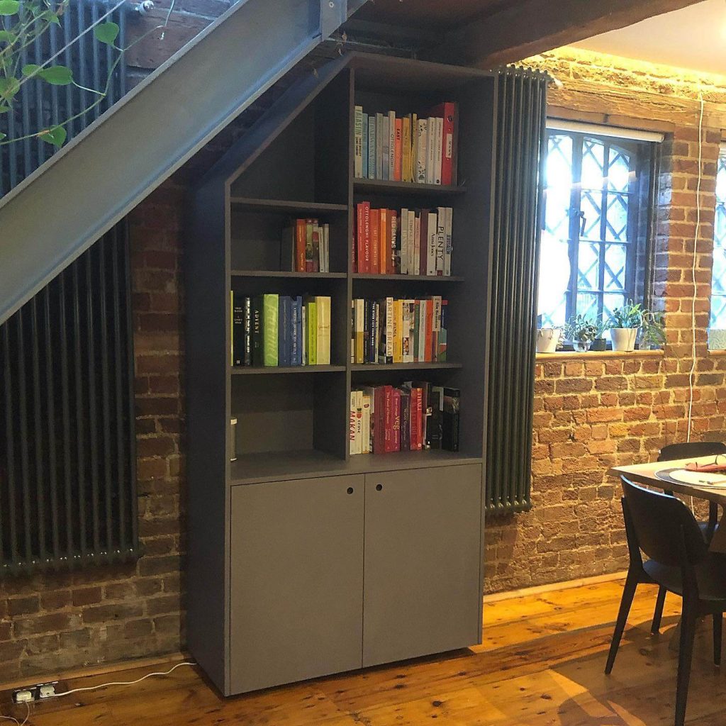 Cleverly Designed Bookshelf Maximizing Space Under the Stairs