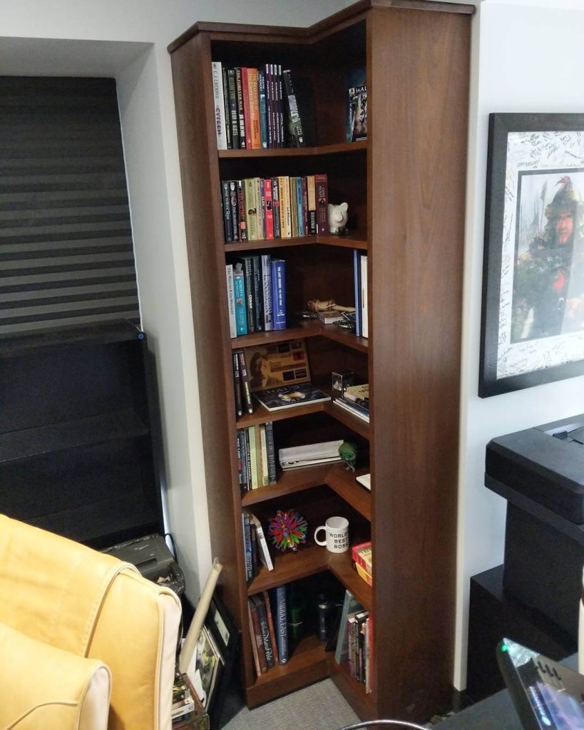 Efficient Storage: Tall Dark Brown Corner Shelf for Cozy Spaces