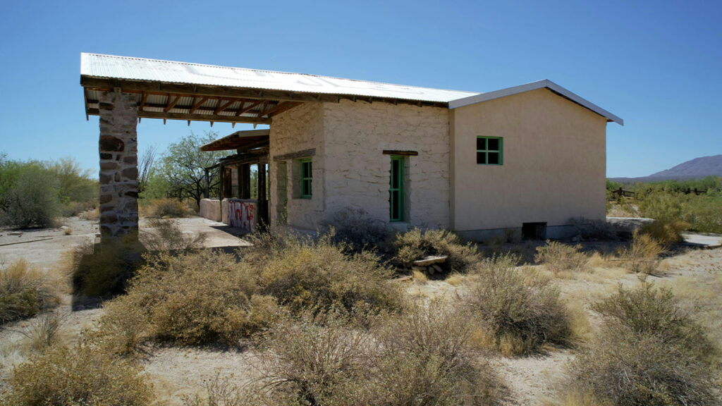 A small building in the middle of a desert