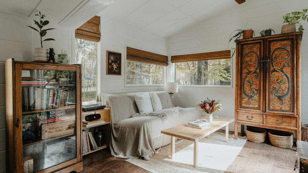 a living room filled with furniture and lots of windows