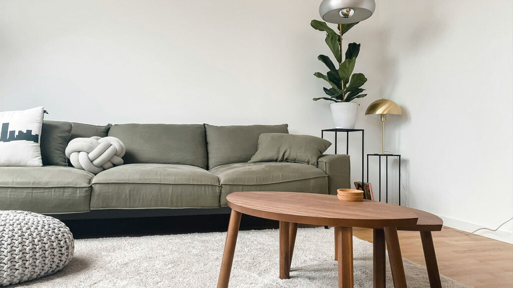 gray 2 seat sofa near brown wooden coffee table