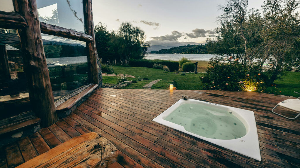 a deck with a tub and a sink on it