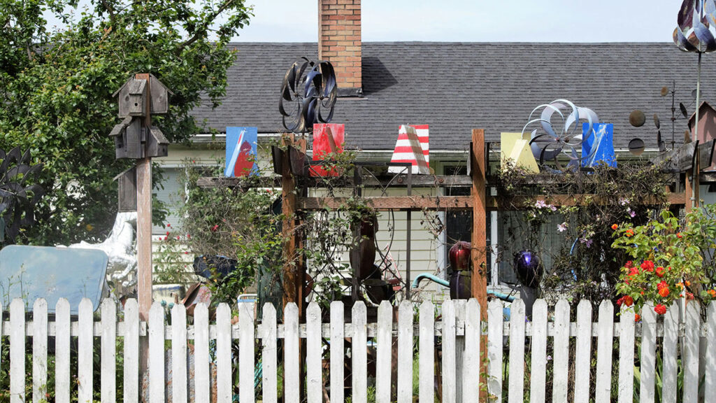 a white picket fence sitting in front of a house