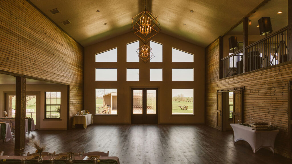 a large room with wooden floors and windows