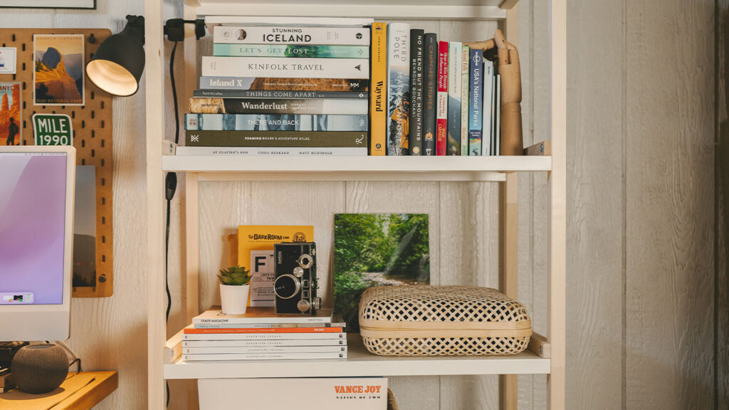 a bookshelf with books and a basket on it