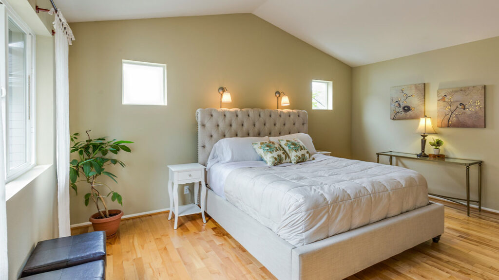 tufted white upholstered bed
