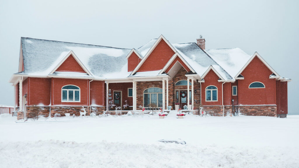 red and gray house during snow