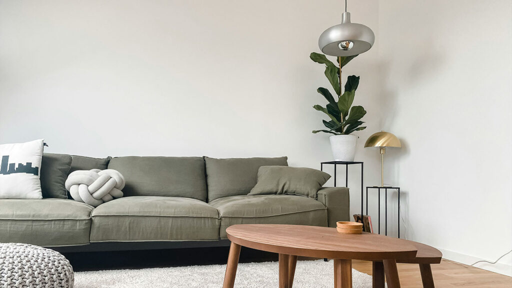 gray 2 seat sofa near brown wooden coffee table