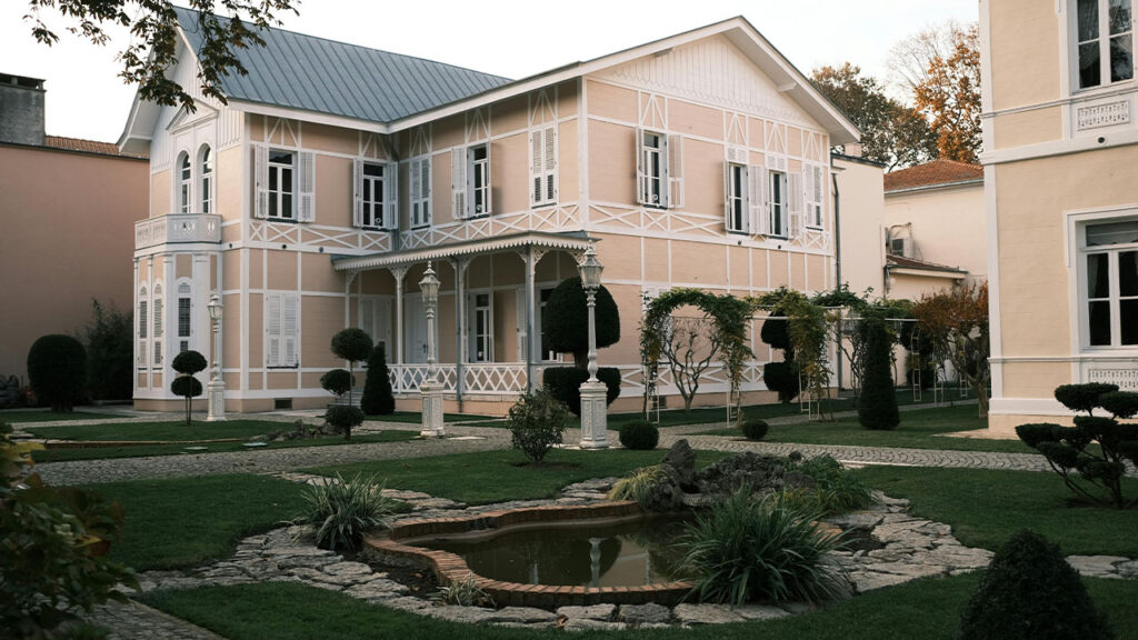 Beige Mansion surrounded with Green Plants