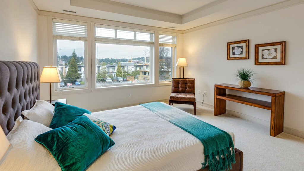 two green and white pillows on empty bed