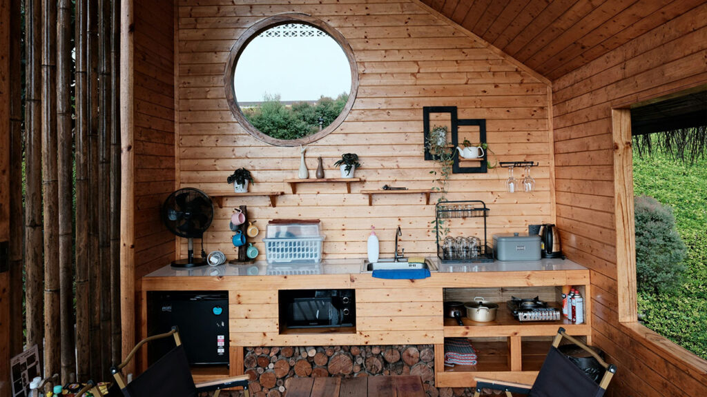 A living room with a round window and wooden walls