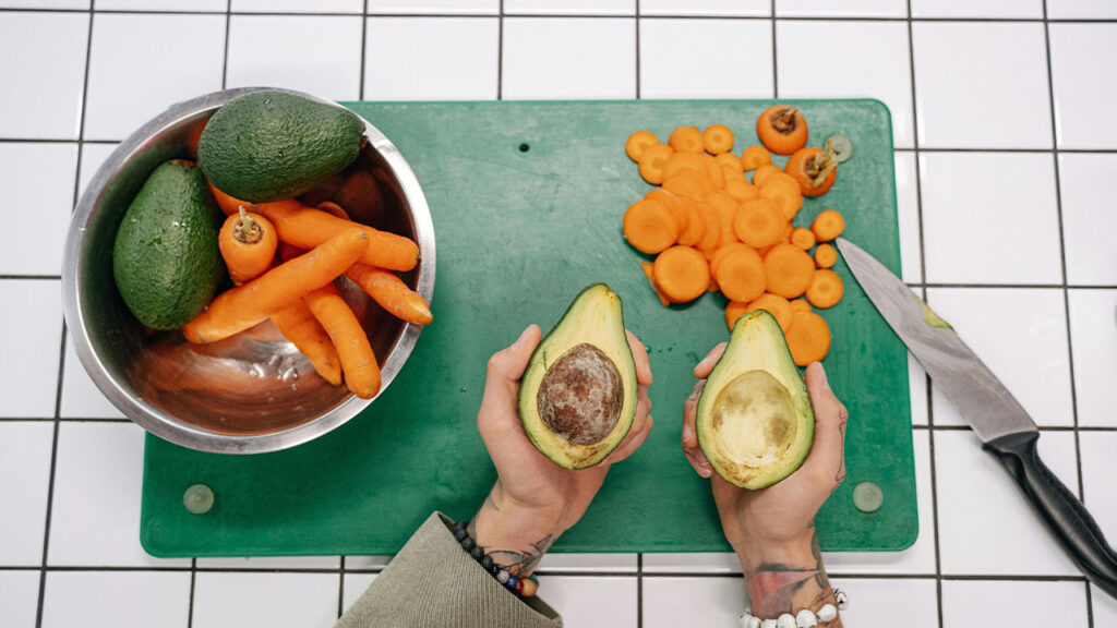 Sliced Carrots and Avocado on Green Chopping Board