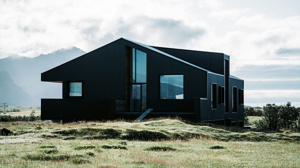 black 2-storey house under white clouds