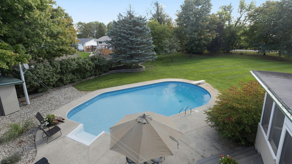 an aerial view of a backyard with a swimming pool