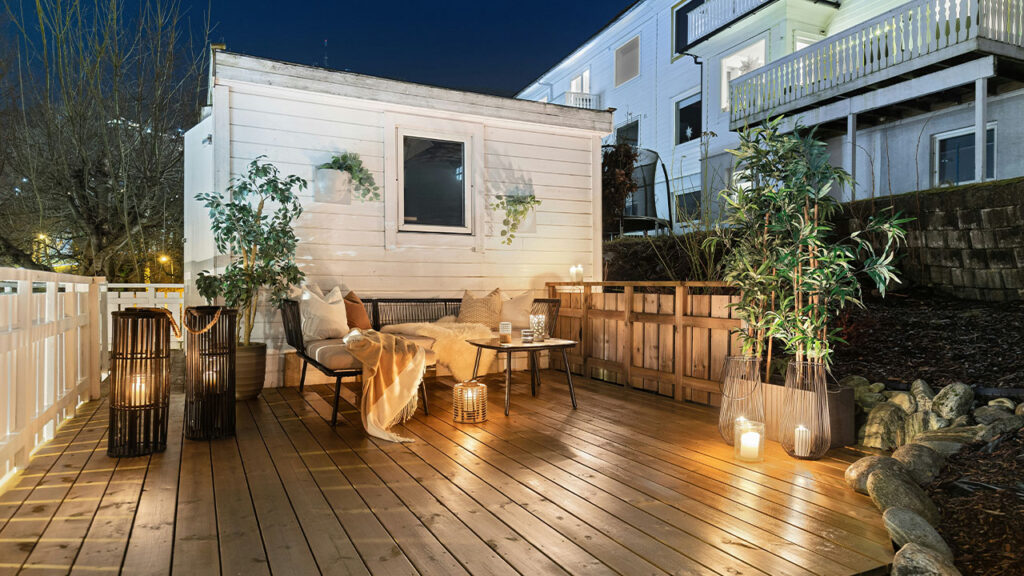 A wooden deck with a table and chairs