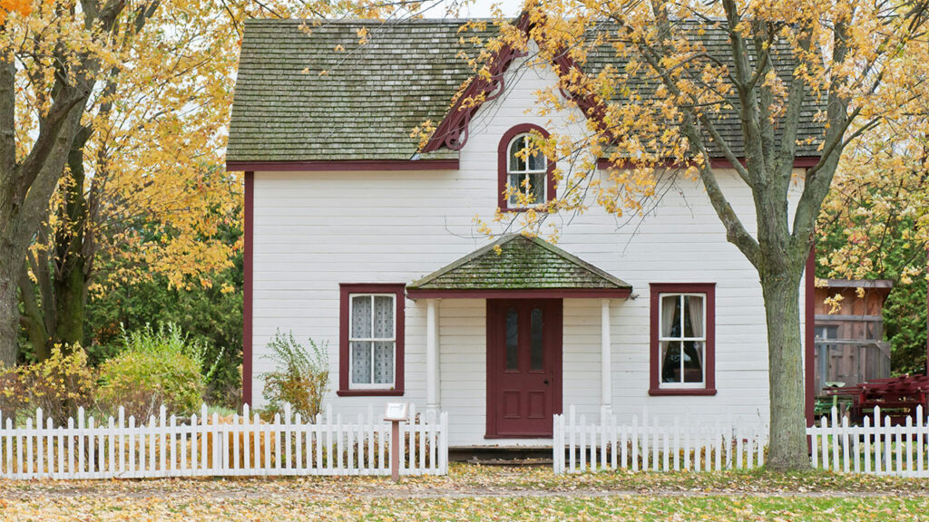 White and Red Wooden House With Fence
