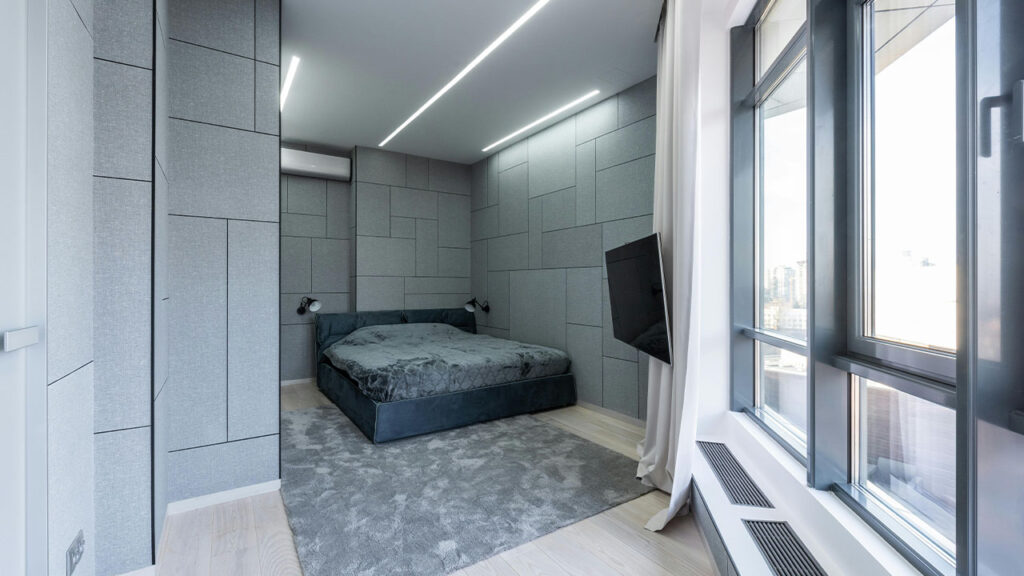 Bedroom interior with TV and window near bed on carpet