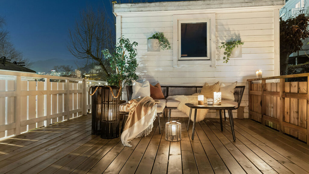 A wooden deck with a table and chairs