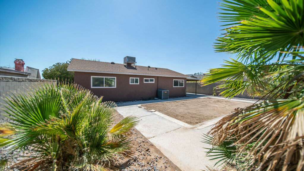 a brown house with a palm tree in front of it