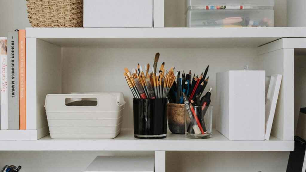 Art supplies on shelves in studio