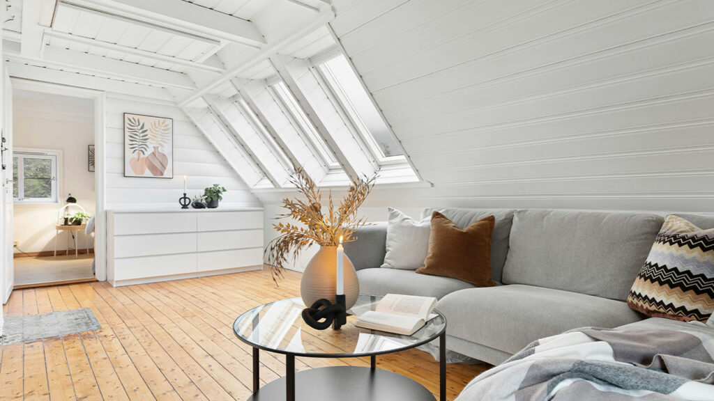 A living room filled with furniture and white walls