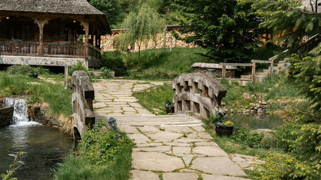 a stone path leading to a wooden house