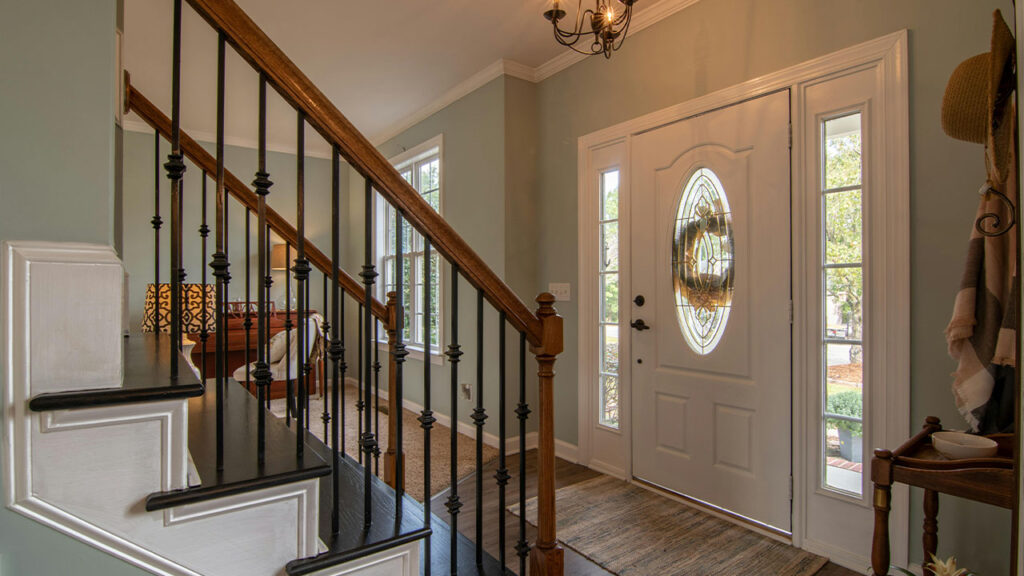 Brown Wooden Staircase With Brass Chandelier