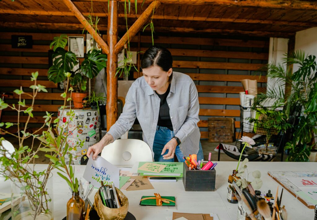 Antoni Shkraba / Pexels A woman inspecting calligraphy work.