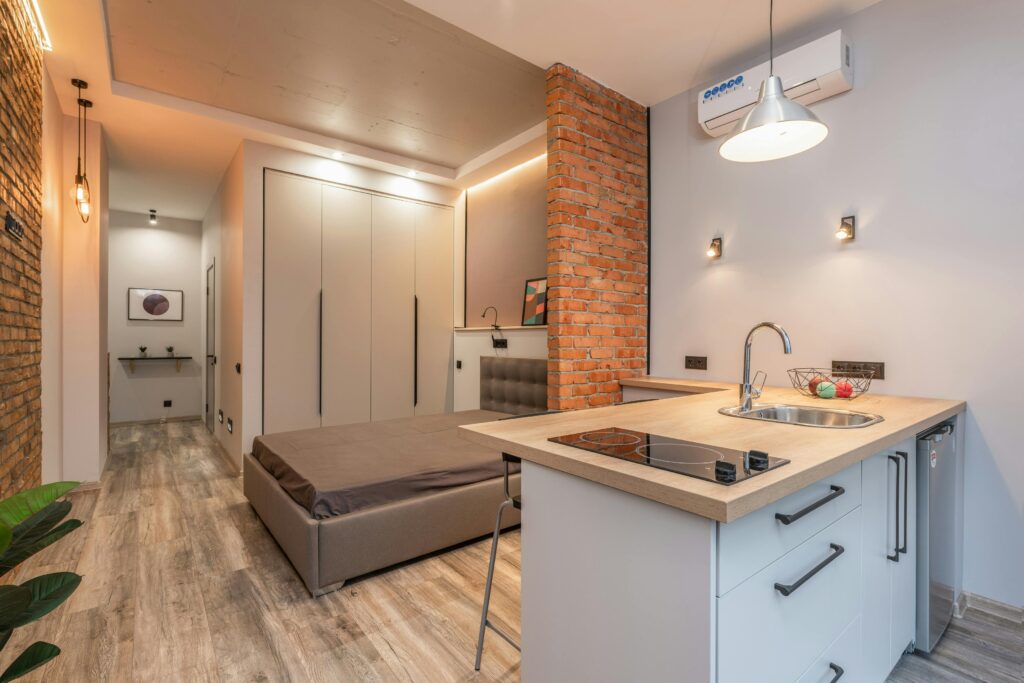 A studio apartment with a tiny kitchen.