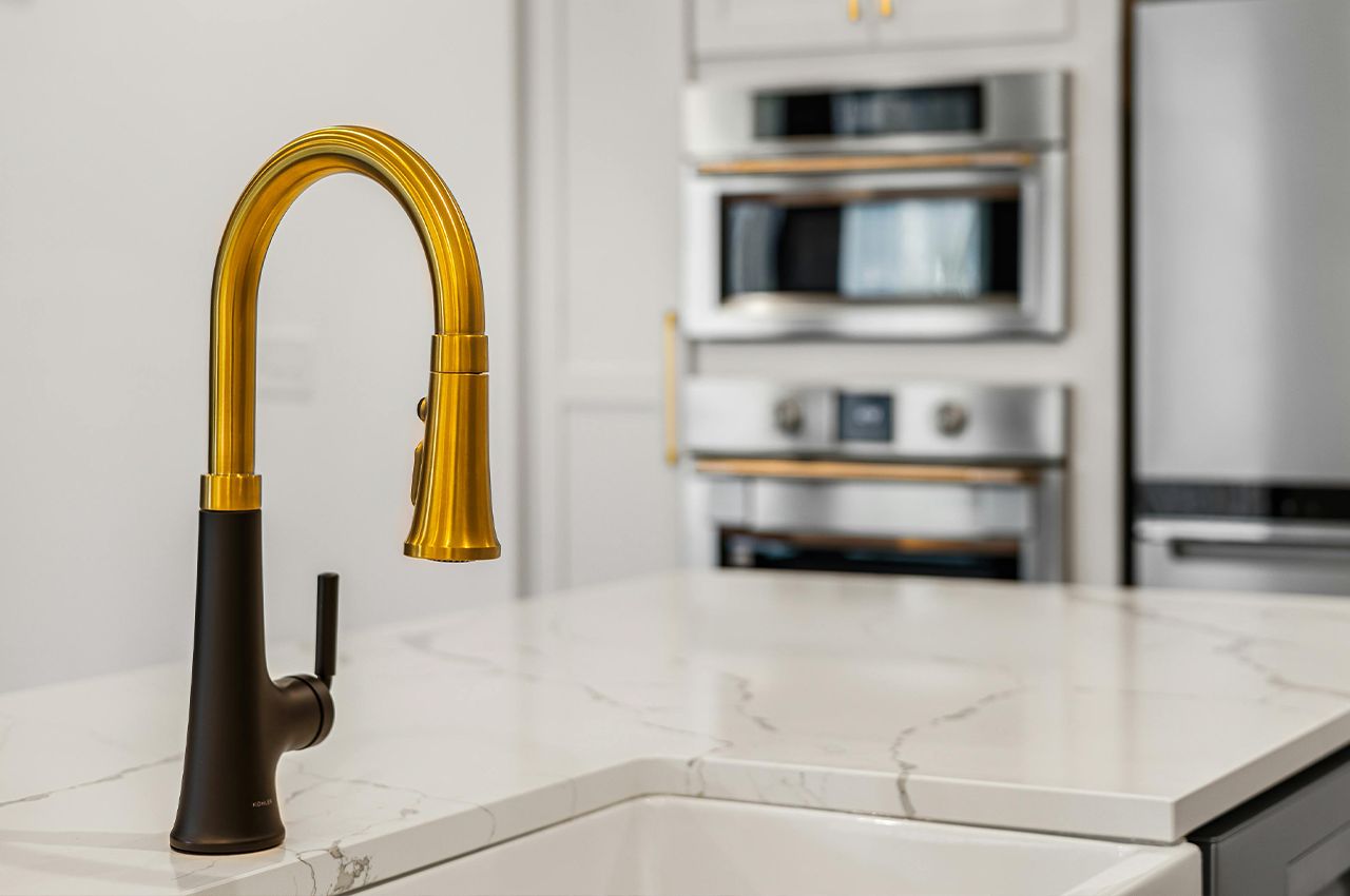 Statement brass faucet in kitchen
