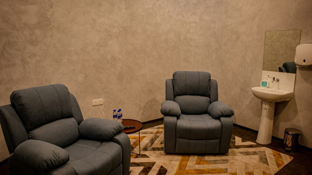 a living room with two recliners and a sink
