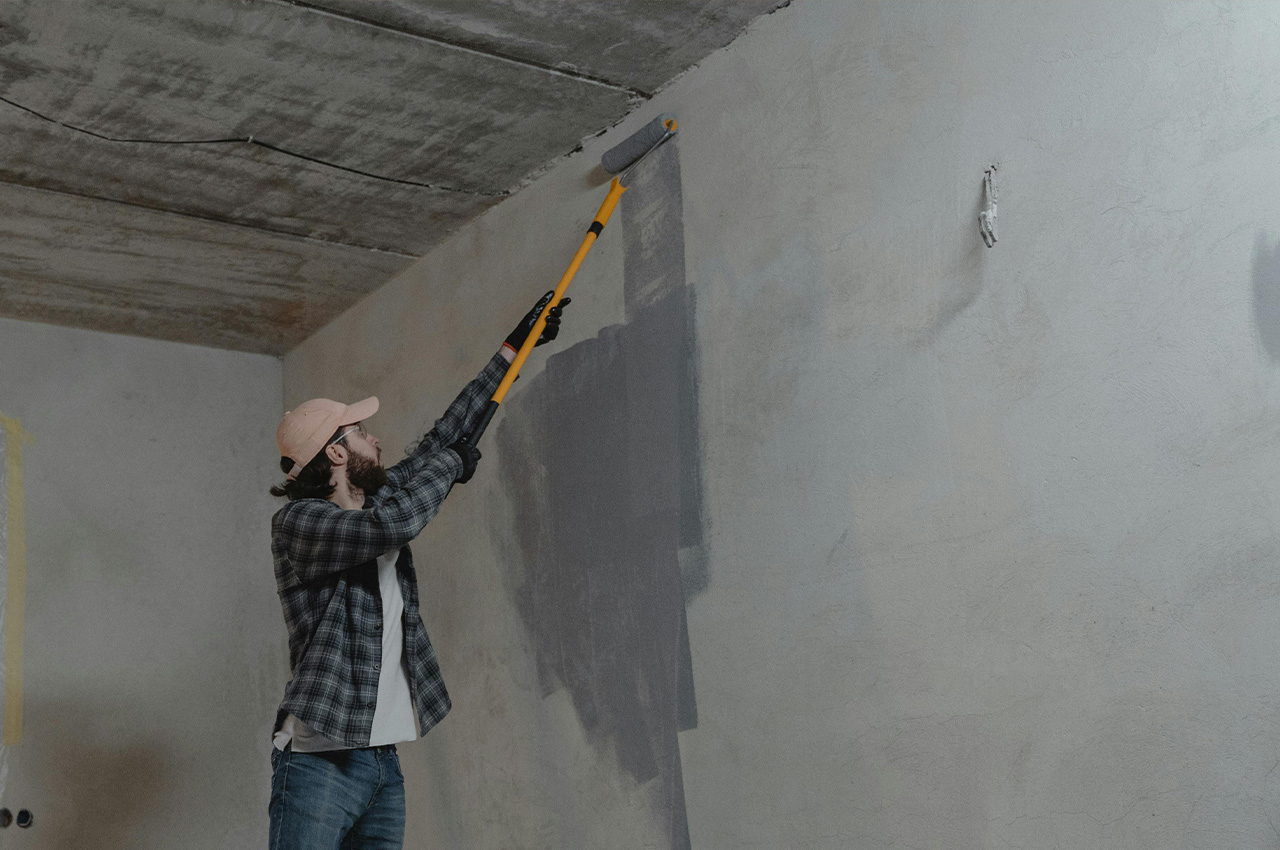 man painting a wall