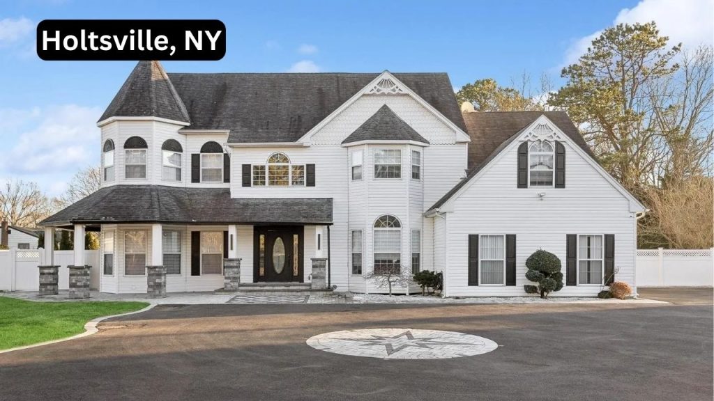 Elegant white single-family home in Holtsville, NY, featuring a Victorian-inspired design with a wraparound porch and bay windows.