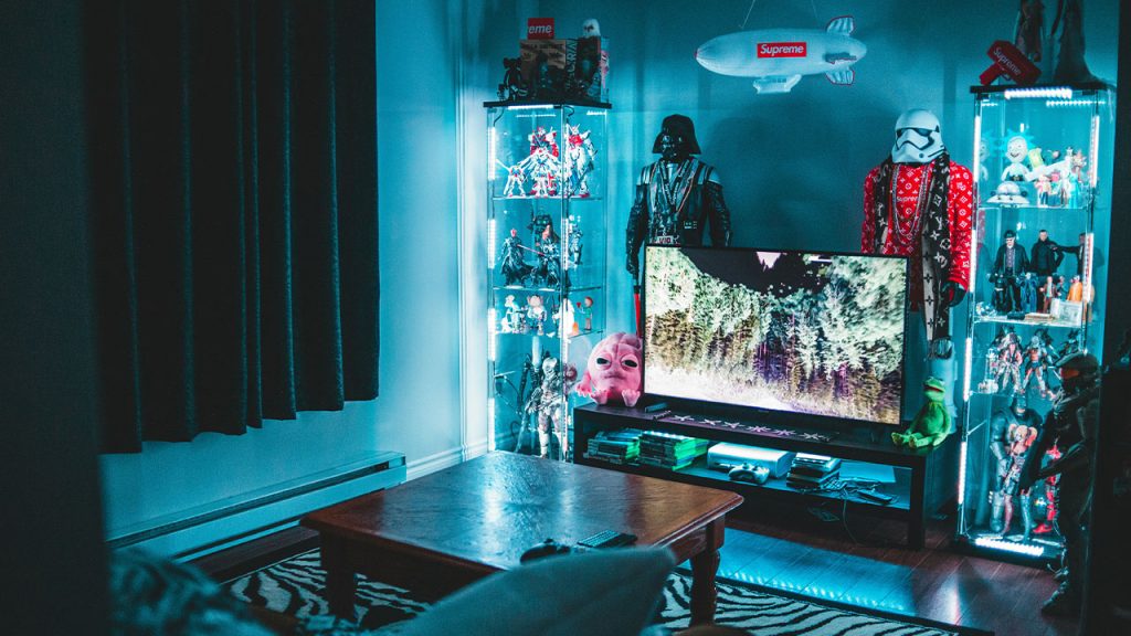 turned on flat screen TV surrounded by Star Wars figures