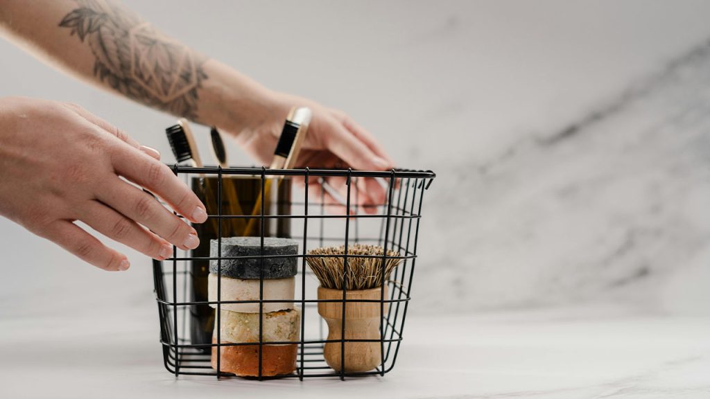 Person Holding Stainless Steel Basket With Brown and Black Metal Tools