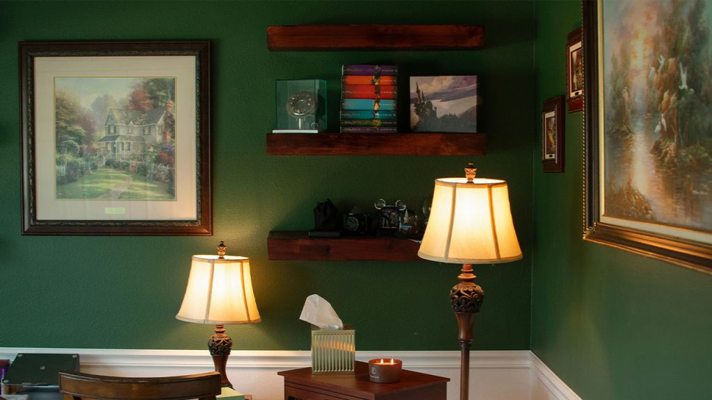 A living room filled with furniture and a painting on the wall