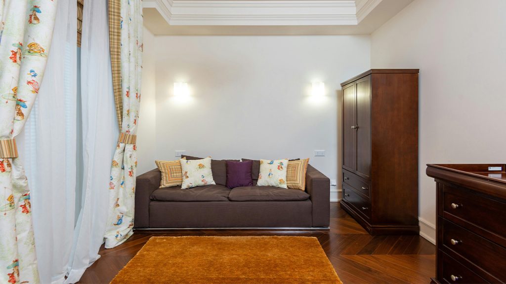 A Wooden Cabinet Near the Couch with Throw Pillows