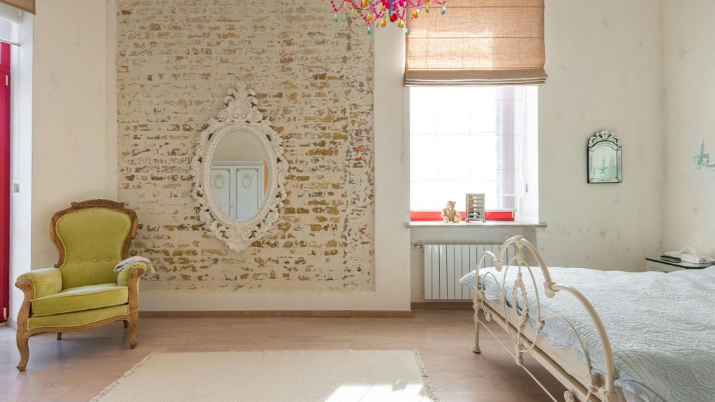 Room with Bed and Armchair and Mirror