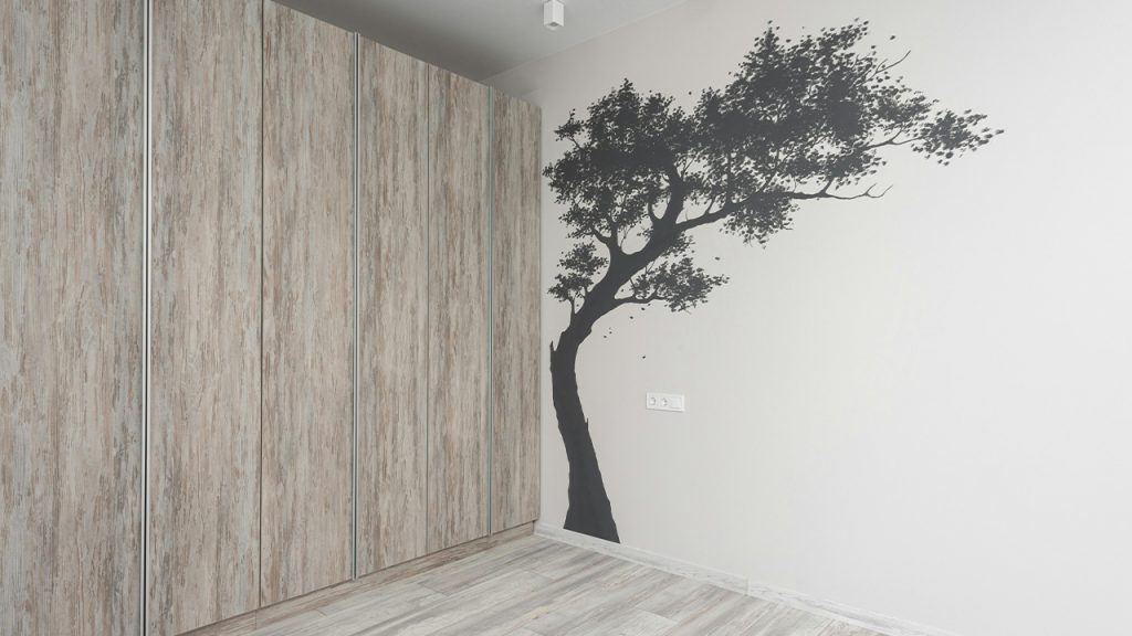 Interior of new house room with decorative tree on wall