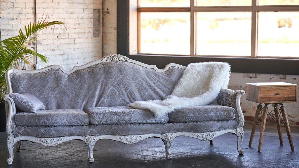 a couch with a blanket on it in a room