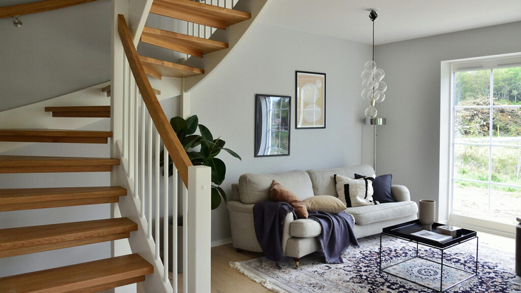 White Sofa Beside Brown Wooden Staircase