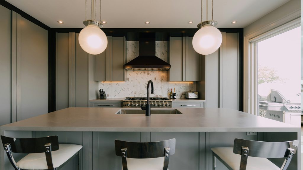 a kitchen with a center island and three chairs