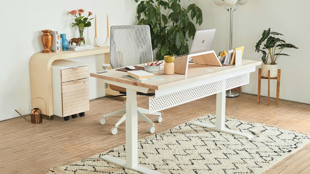 a white desk with a laptop on top of it
