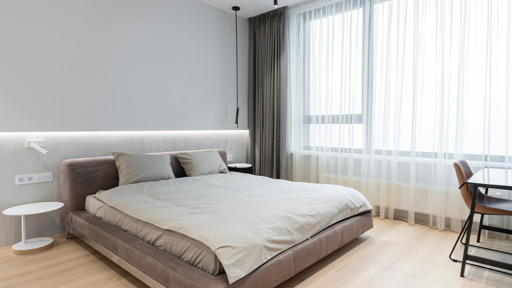 Bedroom with bed near table with chair