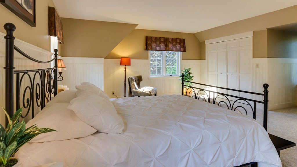 white mattress sheet and four white pillows