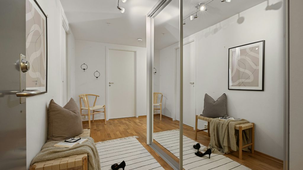 A room with a large mirror and a couch