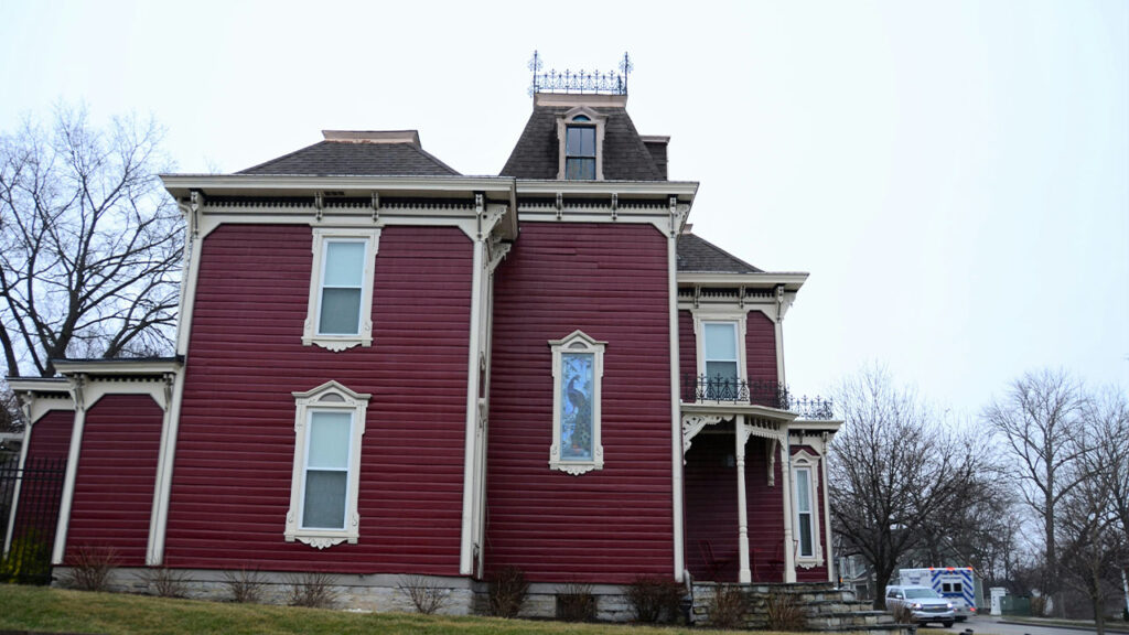 a large red house with a clock tower