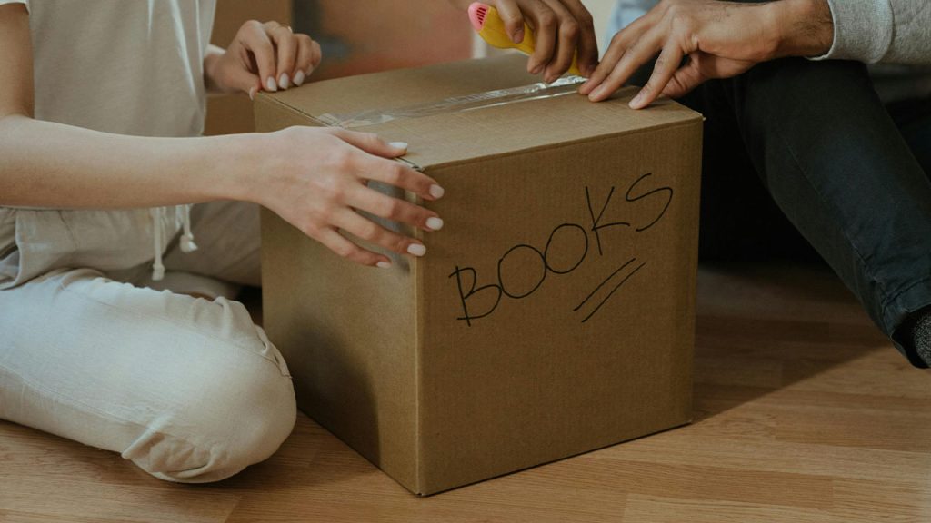 Person Holding Brown Cardboard Box