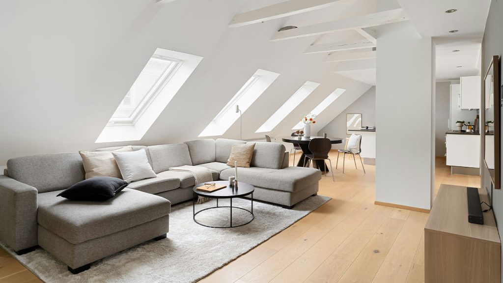 A living room filled with furniture and a skylight
